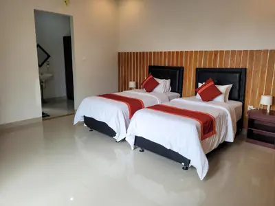 a bedroom with two beds with red pillows at Ramantika Sunset Bay in Nusa Dua