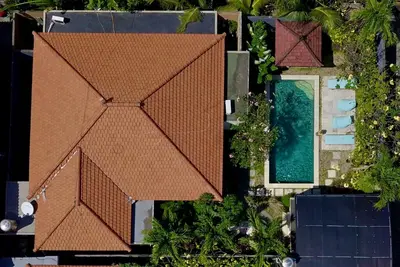 an overhead view of a house with a brown roof at Leluhur 1 Private Pool Villa in Seminyak