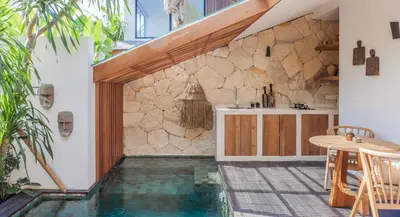 a house with a swimming pool in the middle of a house at Beyond Bespoke Villas in Seminyak