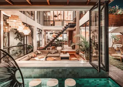 a house with a swimming pool and a living room at Beyond Bespoke Villas in Seminyak