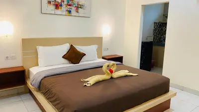 a stuffed animal is sitting on a bed at Mailaku House in Kerobokan