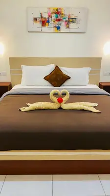 a bed with a pair of swans on it at Mailaku House in Kerobokan