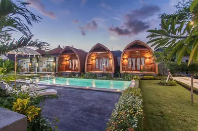 an exterior view of a villa with a swimming pool at Mailaku House in Kerobokan