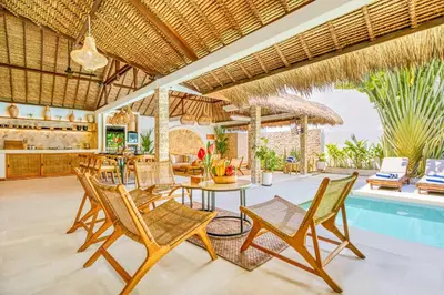 a villa with a pool and a table and chairs at Villa Barcelona - Private 6 BDR Brand New Villa in Seminyak, Best Location, large Pool & Garden in Seminyak