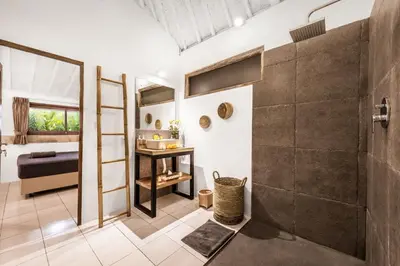 a bathroom with a shower and a bed and a sink at Villa London - Private 4 BDR Villa in Seminyak, Pool & Garden in prime Location in Seminyak
