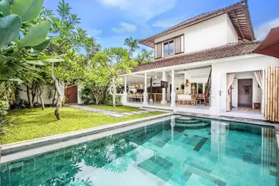 a villa with a swimming pool in front of a house at Villa London - Private 4 BDR Villa in Seminyak, Pool & Garden in prime Location in Seminyak