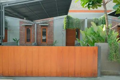 an orange fence in front of a house at Andewi Guest House Denpasar RedPartner - Minimum Stay 30 Nights in Sanur