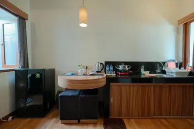 a kitchen with a counter with a wooden bowl on it at Andewi Guest House Denpasar RedPartner - Minimum Stay 30 Nights in Sanur