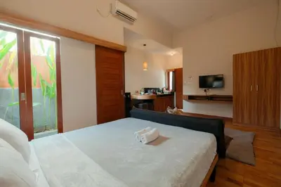 a bedroom with a bed with a box on it at Andewi Guest House Denpasar RedPartner - Minimum Stay 30 Nights in Sanur