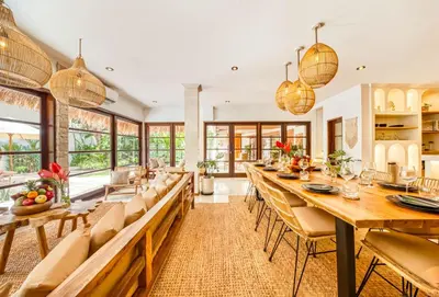 a dining room with a long table and chairs at Villa Aurora - Private 6 BDR Villa in Seminyak, prime Location, Pool & Garden in Seminyak