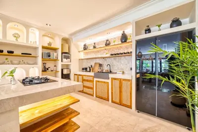 a kitchen with a large island with a counter top at Villa Aurora - Private 6 BDR Villa in Seminyak, prime Location, Pool & Garden in Seminyak