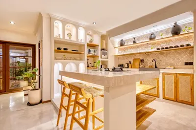 a kitchen with a large island with bar stools at Villa Aurora - Private 6 BDR Villa in Seminyak, prime Location, Pool & Garden in Seminyak