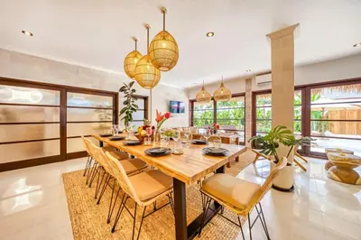 a dining room with a wooden table and chairs at Villa Aurora - Private 6 BDR Villa in Seminyak, prime Location, Pool & Garden in Seminyak
