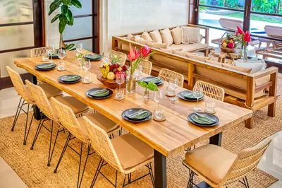 a wooden table in a room with chairs and a couch at Villa Aurora - Private 6 BDR Villa in Seminyak, prime Location, Pool & Garden in Seminyak