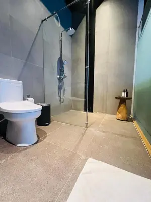 a bathroom with a toilet and a shower at Rumah Kahyangan in Canggu