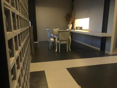 a dining room with a table and chairs on a tiled floor at Rumah Kahyangan in Canggu