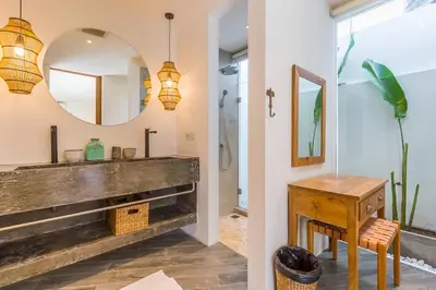 a bathroom with a wooden sink and a mirror at Villa KIU by Alfred in Bali in Seminyak