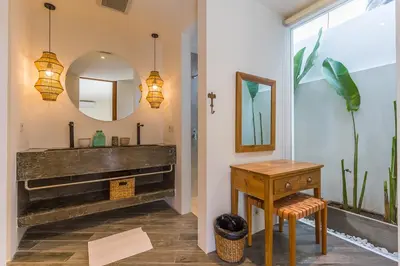a bathroom with a sink and a mirror at Villa KIU by Alfred in Bali in Seminyak