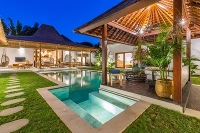 a villa with a swimming pool and a house at Villa KIU by Alfred in Bali in Seminyak