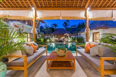 an outdoor patio with couches and a pool at Villa KIU by Alfred in Bali in Seminyak