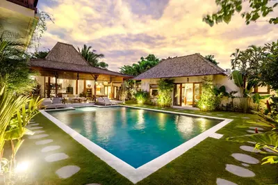 a villa with a swimming pool in front of a house at Villa Nabi by Alfred in Bali in Seminyak