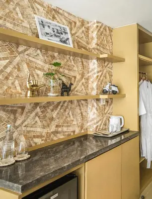a kitchen with a counter with a mosaic wall at MAMAKA by Ovolo in Kuta