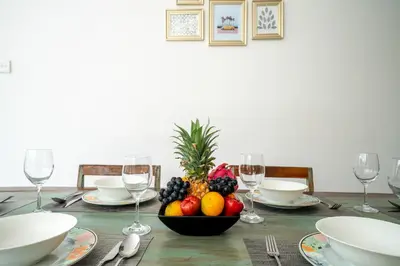 a table with a bowl of fruit and wine glasses at Villa Devina - Seminyak in Seminyak