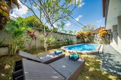 a backyard with a swimming pool with a patio furniture at Villa Devina - Seminyak in Seminyak