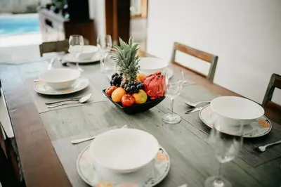 a wooden table with a bowl of fruit on it at Villa Devina - Seminyak in Seminyak