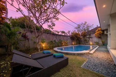a swimming pool in the yard of a house at Villa Devina - Seminyak in Seminyak