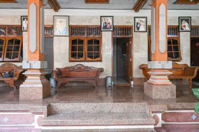 a building with furniture in the middle of a room at Ceria Guesthouse Seminyak Mitra RedDoorz in Seminyak