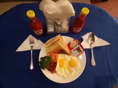 a plate of breakfast food on a blue table at Taman Ayu Legian Hotel in Legian