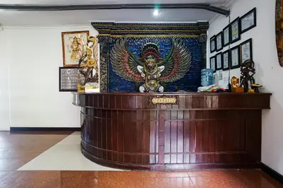 a counter in a room with a statue on it at Taman Ayu Legian Hotel in Legian