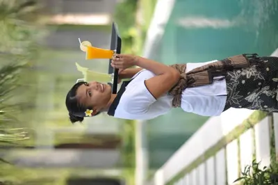 a young woman is playing with a toy gun at Ganga Hotel & Apartment in Denpasar