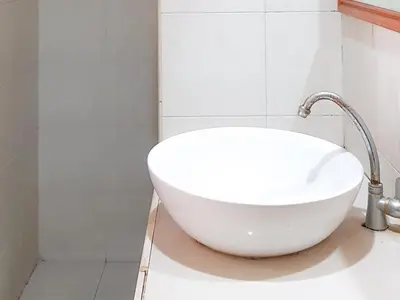 a bathroom with a white sink and a shower at KoolKost at Poppies Lane Street - Minimum stay 30 nights in Denpasar