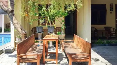 a table and two chairs sitting next to a house at KoolKost at Poppies Lane Street - Minimum stay 30 nights in Denpasar