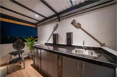 a kitchen with a sink and a chair at La Terra Villas Canggu Kuta Bali in Canggu
