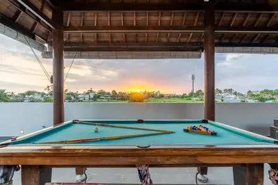 a pool table with a view of the sunset at La Terra Villas Canggu Kuta Bali in Canggu