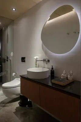 a bathroom with a sink and a toilet and a mirror at OXO Townhouses Umalas - Close to Seminyak & Canggu in Seminyak