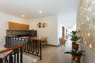 a kitchen and dining room with a table and a counter at Pondok Bobo Seminyak in Seminyak