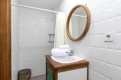 a bathroom with a sink and a mirror at Ruang Tekuni in Legian