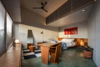 a bedroom with a bed and a desk in it at T Lofts in Seminyak