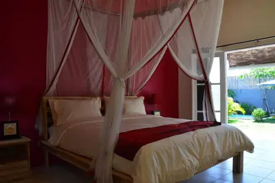 a bedroom with a bed with a canopy at Villa Eden Seminyak in Seminyak