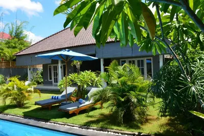 a house with a swimming pool next to a resort at Villa Eden Seminyak in Seminyak