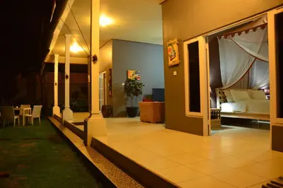 a living room with a bed and a room with a table at Villa Eden Seminyak in Seminyak