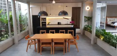 a kitchen and dining room with a wooden table and chairs at Villa Teejay - architect-designed luxury in perfect Petitenget location in Seminyak