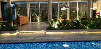 a pool in the middle of a building with plants at Villa Teejay - architect-designed luxury in perfect Petitenget location in Seminyak
