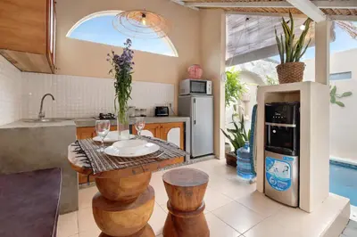 a kitchen with a table with wine glasses on it at Seminyak Beach Bungalow Studio Villa 1 with private pool SBB1 in Seminyak