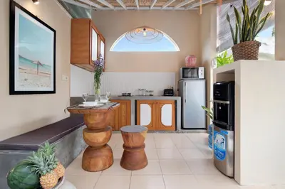a kitchen with a table and a refrigerator at Seminyak Beach Bungalow Studio Villa 1 with private pool SBB1 in Seminyak