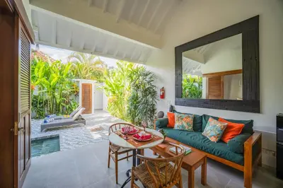 a living room with a couch and a table at Villa Joli in Seminyak